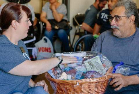 Women with red hair placing her hand on a basket on a man's lap Women with red hair placing her hand on a basket on a man's lap